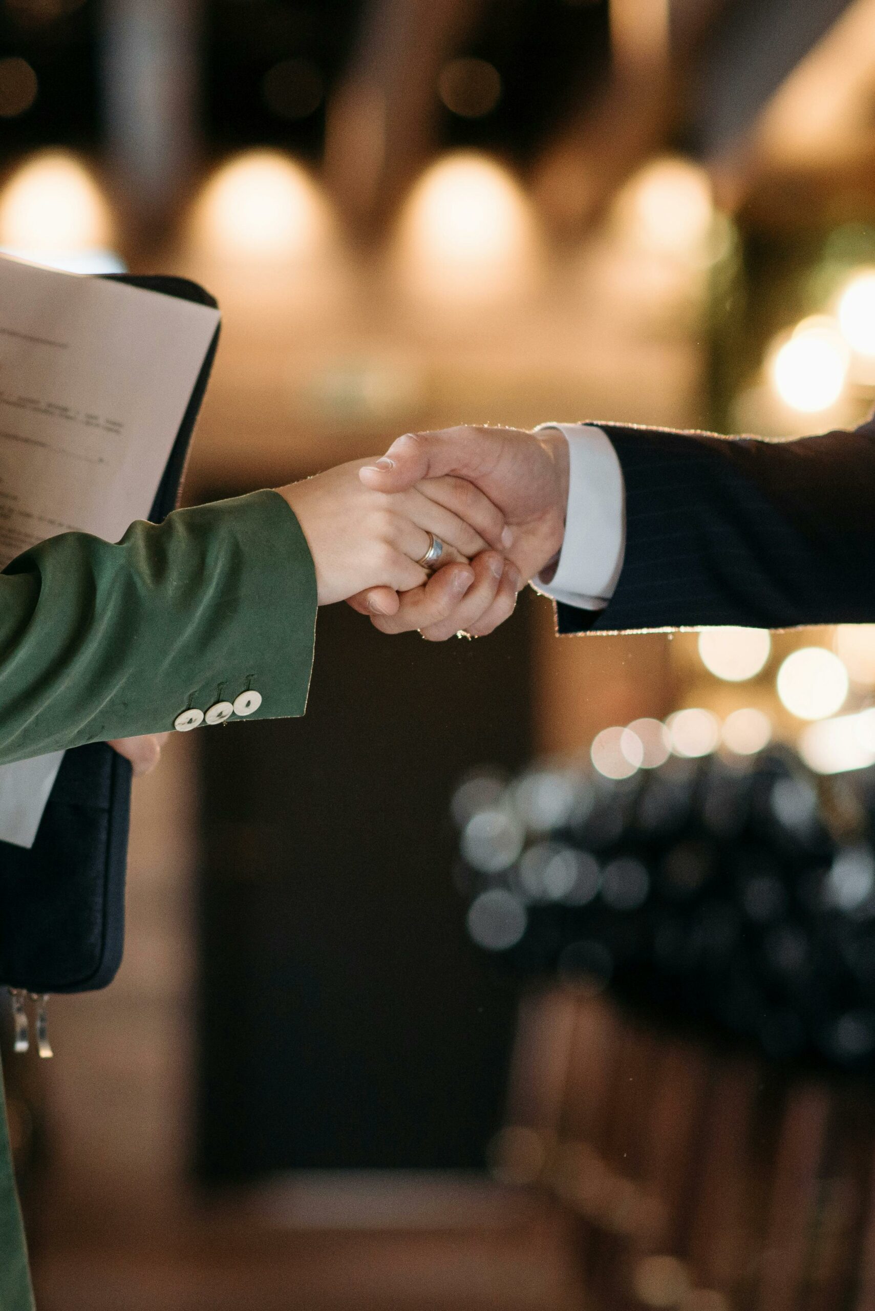 Close-up of two professionals shaking hands, symbolizing a successful partnership agreement.